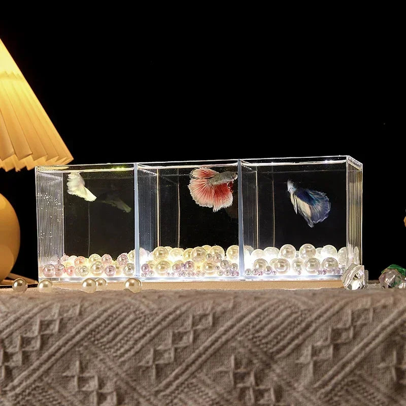 A small barrel-shaped fish tank with a built-in lighting system, a tabletop miniature landscape, and a mini aquarium s