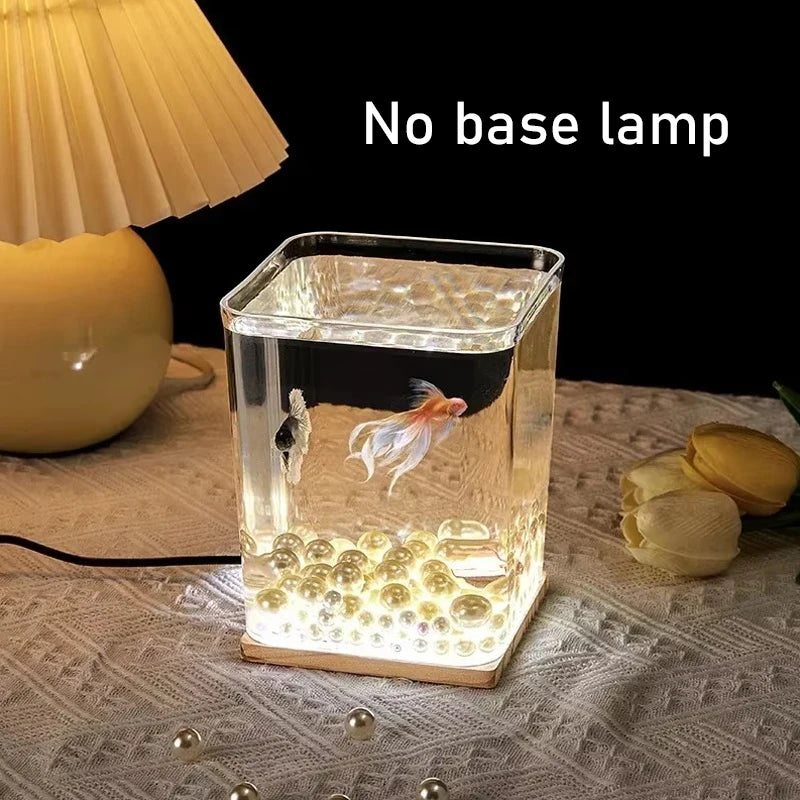 A small barrel-shaped fish tank with a built-in lighting system, a tabletop miniature landscape, and a mini aquarium s